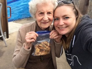 The adorable and delightful Bobbie holding a bag of her Mandelbrot!